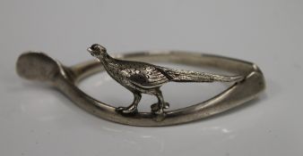 A silver wishbone form napkin ring mounted with a pheasant