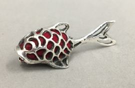 A silver pin cushion in the form of a fish