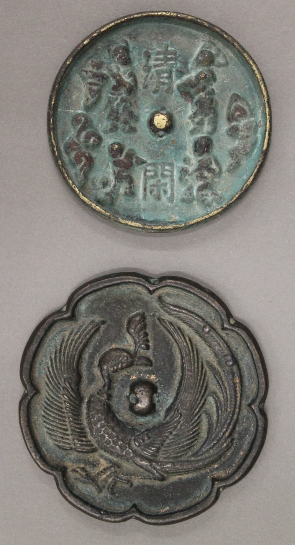 Two Chinese bronze mirrors. Larger 8 cm diameter, smaller 7 cm diameter.