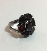 A silver and almandine garnet ring