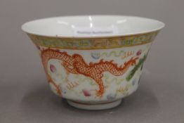 A Chinese porcelain bowl, decorated with a dragon and a phoenix chasing a flaming pearl,