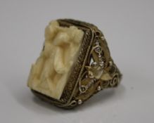 A late 19th/early 20th century Chinese silver gilt ring with carved ivory insert