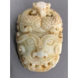 A jade buckle carved as a mythical beast mask
