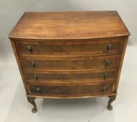 A 20th century bow front chest of drawers, on cabriole legs. 79 cm high; 77 cm wide; 46 cm deep.