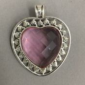 A silver heart shaped pendant