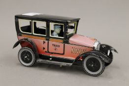 A French tin plate model of a taxi with driver