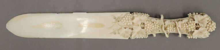A Victorian carved ivory page turner/letter knife. 31 cm long; 4 cm wide.