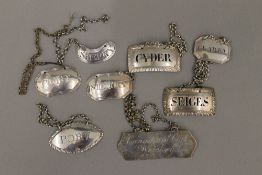 A collection of silver and silver plated decanter labels,