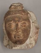 An Eastern carved stone Buddha head. 14 cm high.