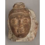 An Eastern carved stone Buddha head. 14 cm high.