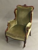 A Victorian green upholstered armchair