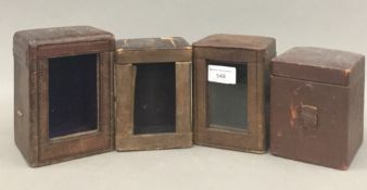 Four 19th century carriage clock cases. Largest 15 cm high; 10.75 cm wide; 10.5 cm deep.