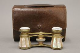 A leather cased pair of mother-of-pearl opera glasses