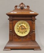 A late 19th century walnut cased Ansonia mantle clock