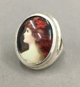 A silver ring depicting a portrait of a girl