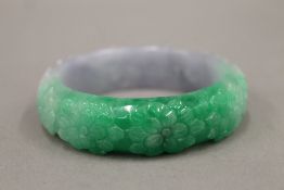 A carved jade bangle. 7.5 cm diameter.