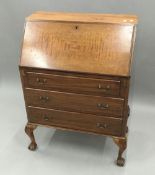 An early 20th century mahogany bureau on cabriole legs