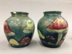 A pair of Moorcroft Claremont pattern vases. 9 cm high.