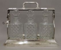 A silver plated three bottle tantalus