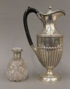 A loaded silver water jug (19 troy ounces total weight) and a cut glass silver topped scent bottle