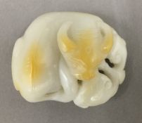 A white jade carving of a bull