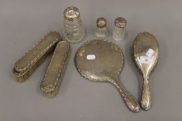 A silver backed dressing set, silver topped jars, etc.