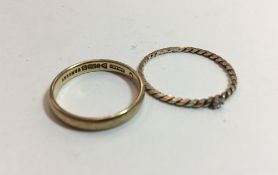 A 9 ct gold band together with a bi-colour gold ring (3 grammes)