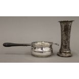 A silver tea strainer and a loaded beaten silver vase (6.