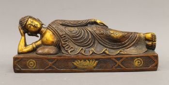 A bronze model of buddha laying down. 30.5 cm long; 12 cm high; 10 cm deep.