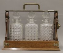 An oak plate mounted three bottle tantalus