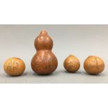 An antique Chinese double gourd profusely decorated with boys in various pursuits and three smaller