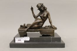 A bronze model of a nude girl smoking