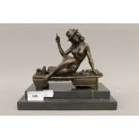 A bronze model of a nude girl smoking