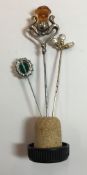 An Art Nouveau silver hat pin and two others