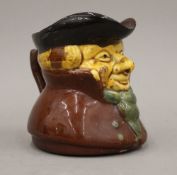 A 19th century treacle glaze pottery Toby jug