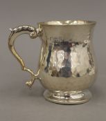 A beaten silver Christening mug (5.