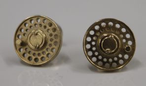 A pair of cufflinks formed as fishing reels