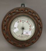 An oak cased barometer with carved chain link border