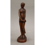 A carved wooden figure of an Art Nouveau girl