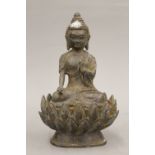 A bronze model of a Buddha seated on a lotus flower