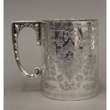 A Victorian embossed silver Christening mug (7.