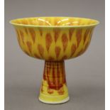 A Chinese porcelain stem cup, with all over yellow and red decoration,