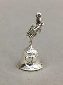 A silver bell in the form of a stork