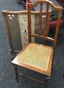 A tapestry inset firescreen and a cane seated bedroom chair