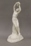 A 19th century Parian model of a naked young lady holding flowers. 35 cm high.