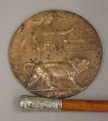 A World War I bronze death plaque awarded to Arthur Derrick and a military swagger stick with