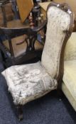 A Victorian walnut framed tapestry covered nursing chair