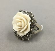 A silver and marcasite ring set with a rose