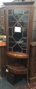 An Edwardian inlaid mahogany standing corner cabinet