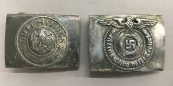 A WWII Nazi belt buckle together with another,